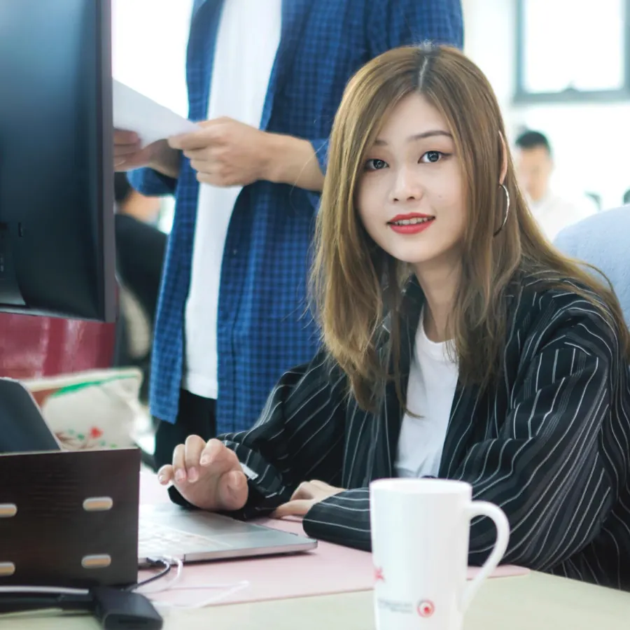 Shinetech software developer working at a laptop during an office review
